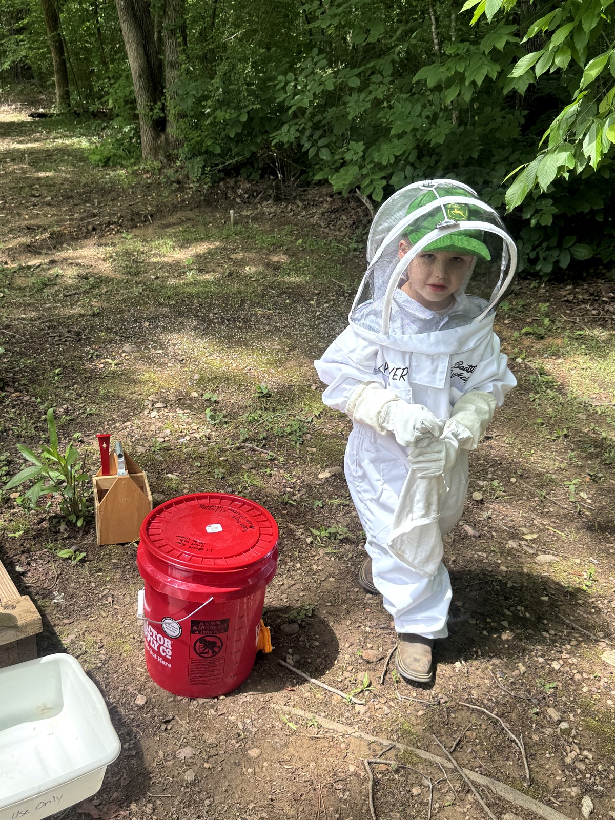 Sawyer suited up at the Bootstrap Beekeeping apiary